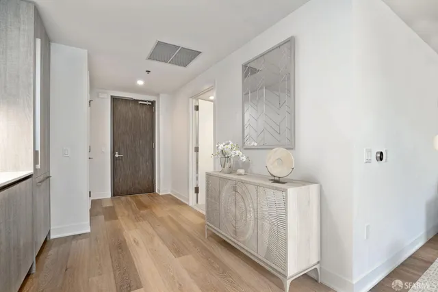 a spacious bathroom with a shower a sink and a mirror