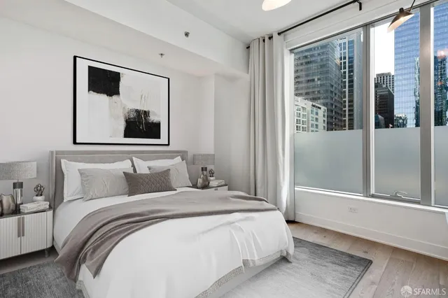 a bedroom with a large bed and a large window