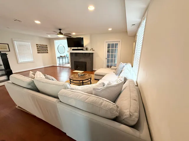 a living room with furniture a fireplace and a flat screen tv