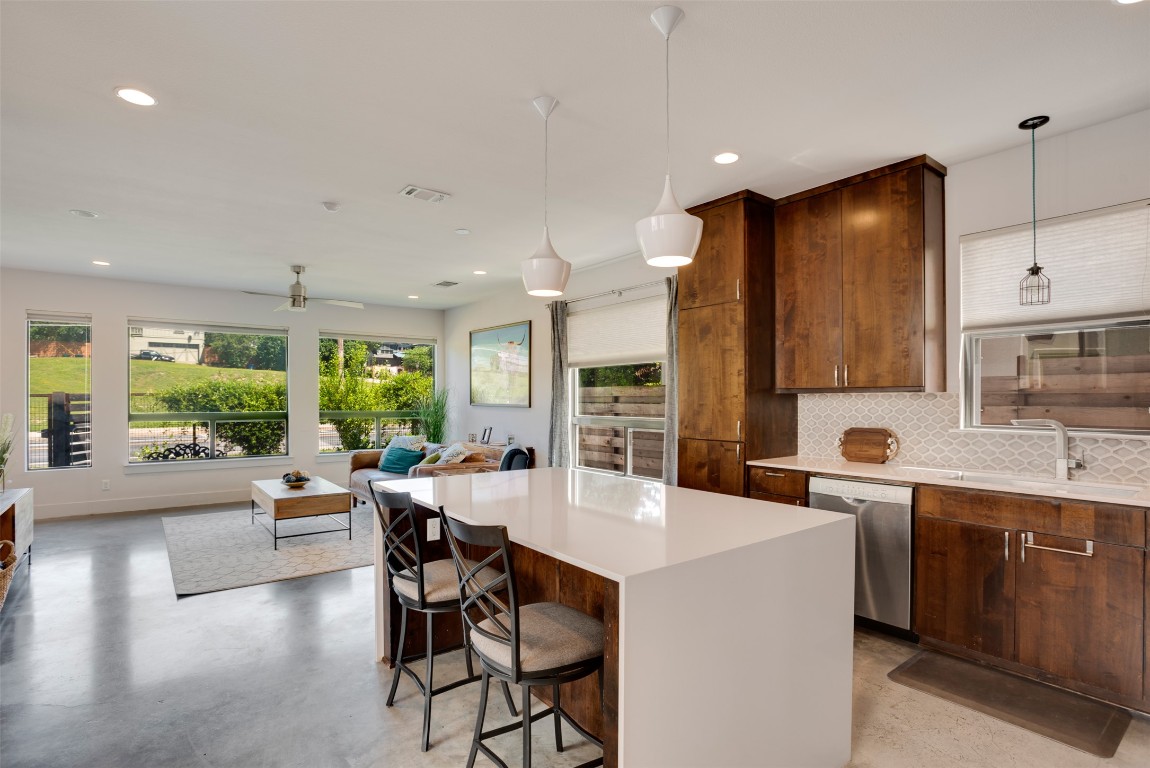 1009 East 12th Street Austin, TX 78702 - Photo 12 of 27 a kitchen with stainless steel appliances kitchen island granite countertop a sink and cabinets