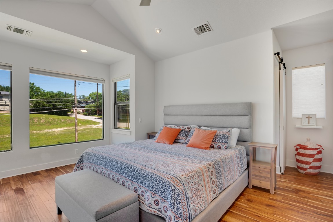 1009 East 12th Street Austin, TX 78702 - Photo 14 of 27 a bedroom with a bed and wooden floor