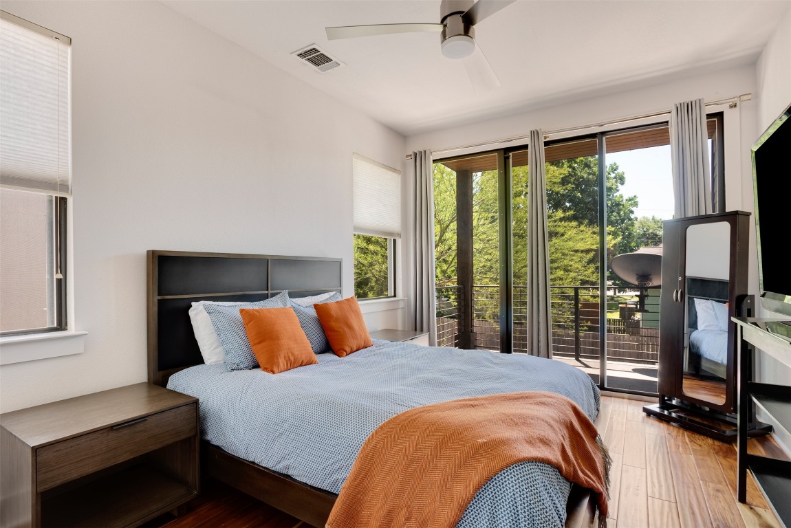 1009 East 12th Street Austin, TX 78702 - Photo 18 of 27 a bedroom with a bed and glass window