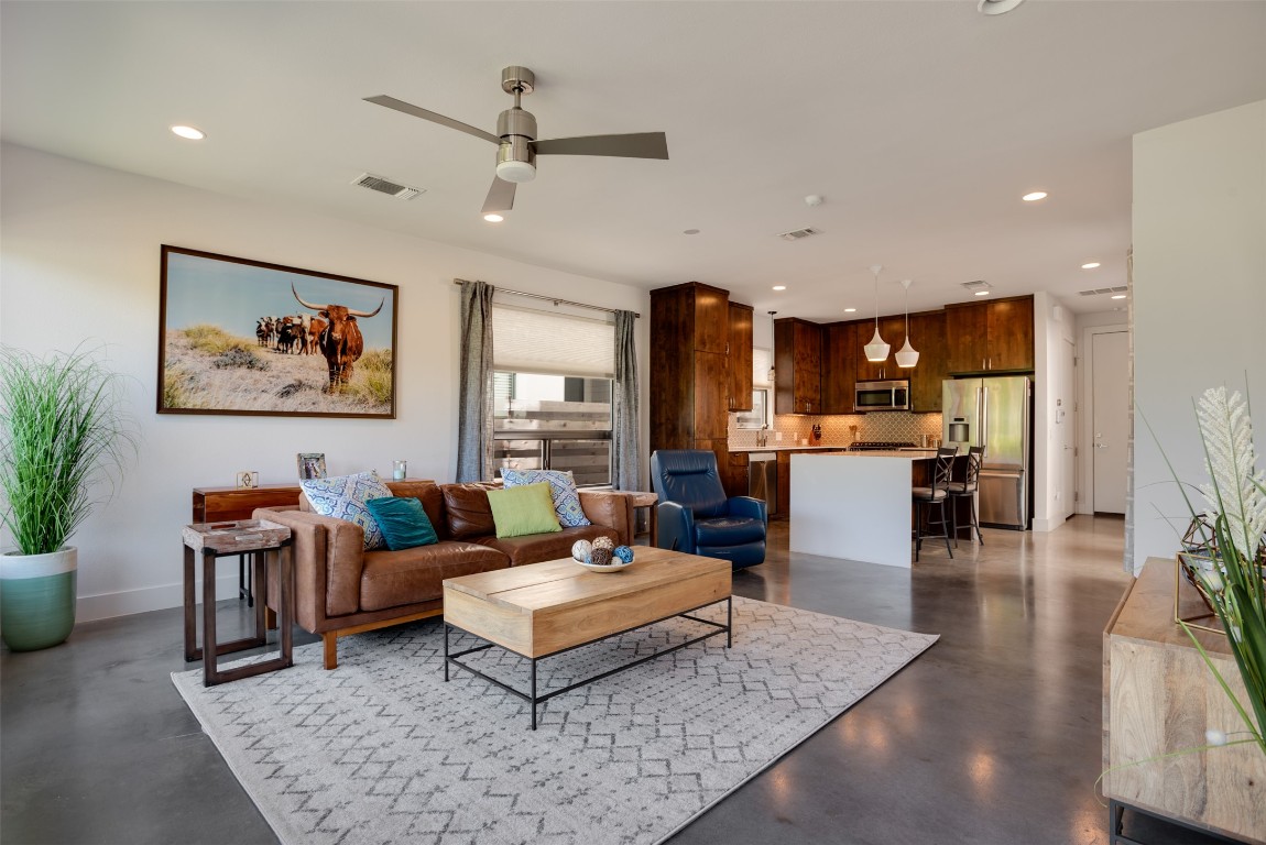 1009 East 12th Street Austin, TX 78702 - Photo 6 of 27 a living room with furniture a rug and a kitchen view