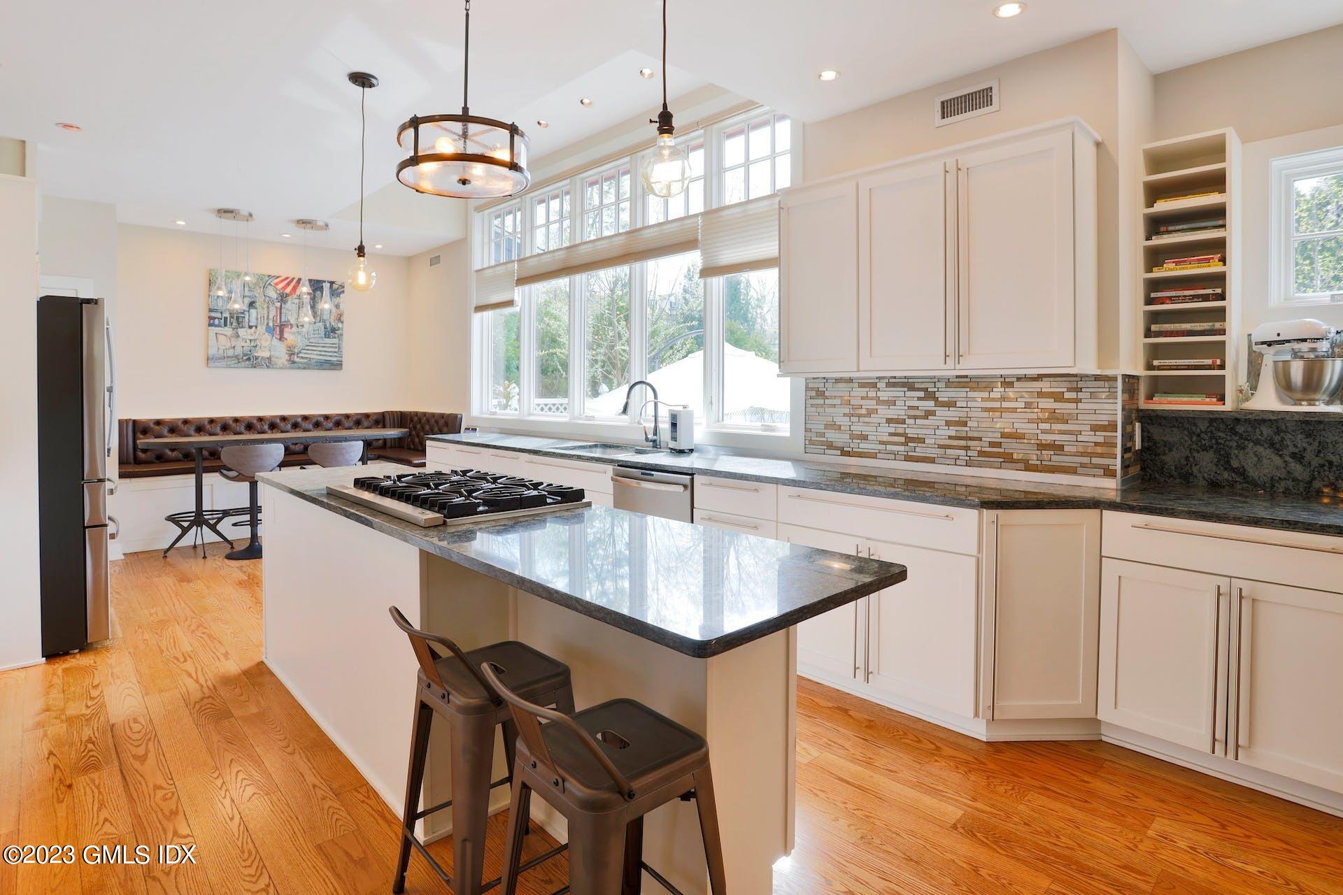 62 Morningside Drive Greenwich, CT 06830 - Photo 13 of 31 a kitchen with granite countertop a sink stove and cabinets