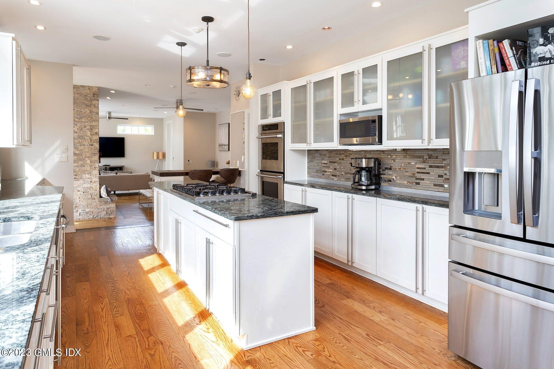 62 Morningside Drive Greenwich, CT 06830 - Photo 15 of 31 a kitchen with stainless steel appliances granite countertop a sink stove and refrigerator