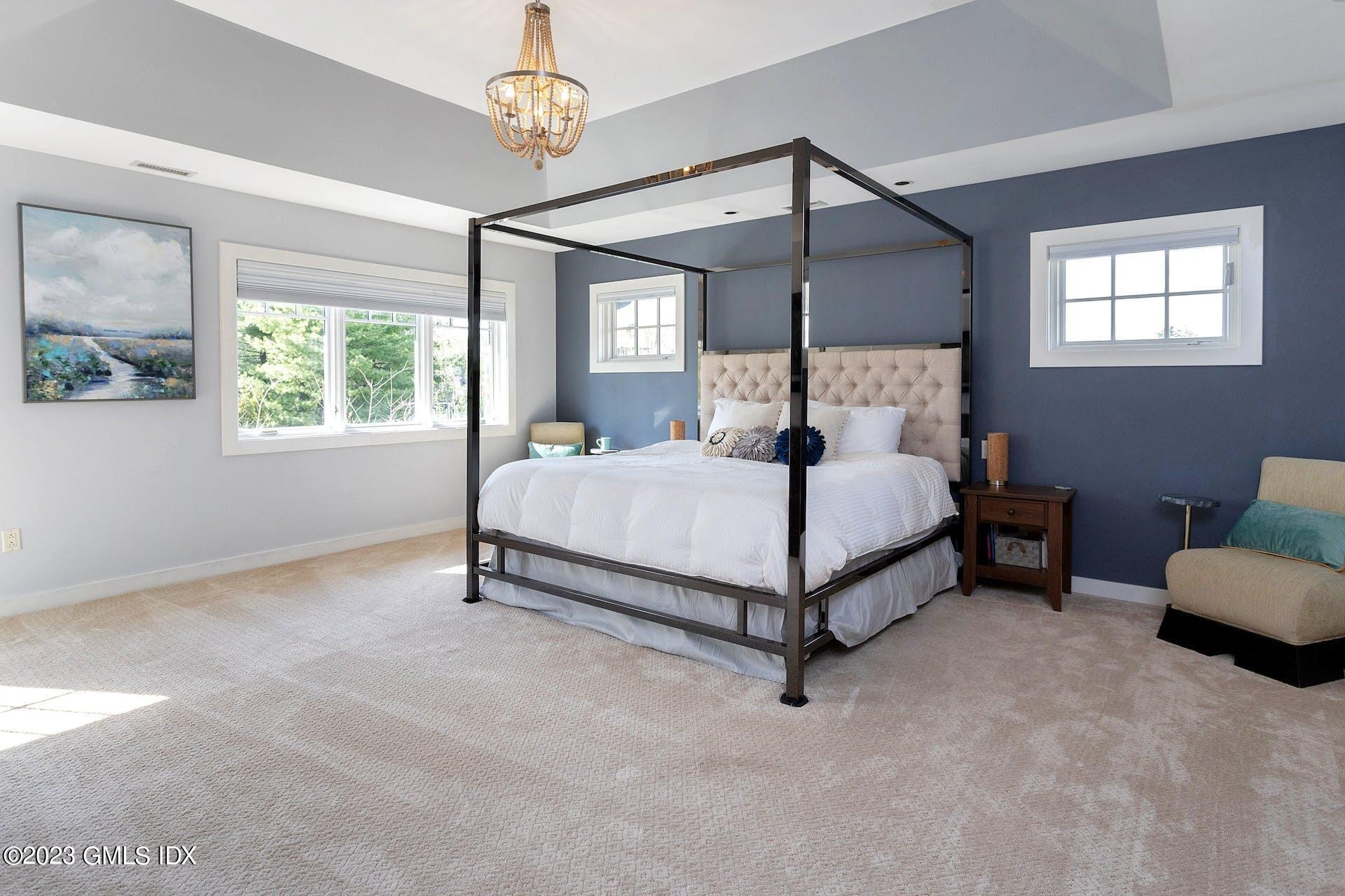 62 Morningside Drive Greenwich, CT 06830 - Photo 16 of 31 a bedroom with a bed chandelier and window