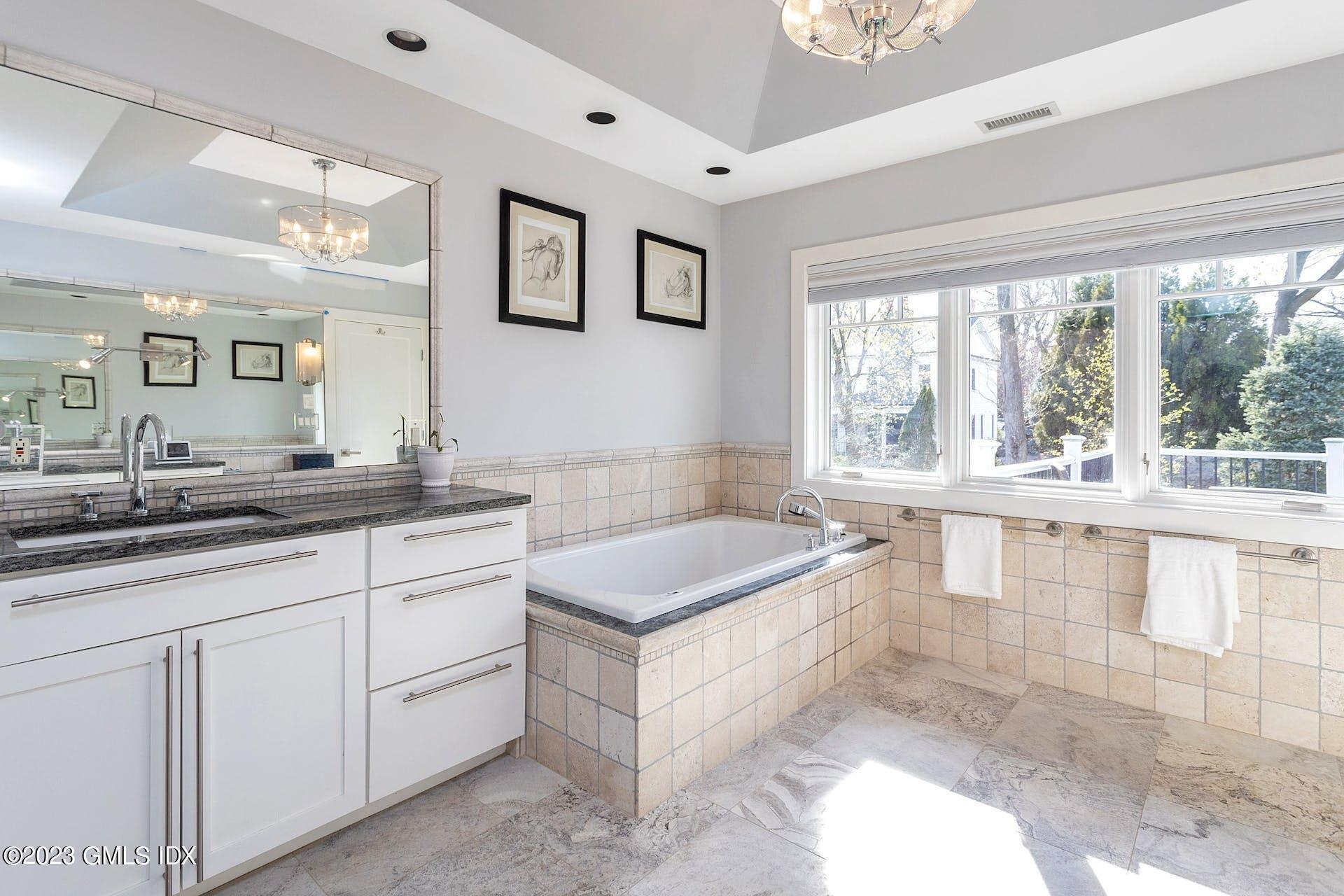 62 Morningside Drive Greenwich, CT 06830 - Photo 18 of 31 a spacious bathroom with a granite countertop tub sink and mirror