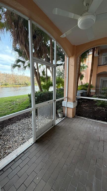 13584 Turtle Marsh Loop, Unit 113 Orlando, FL 32837 - Photo 12 of 29 a view of a porch with furniture and floor to ceiling window