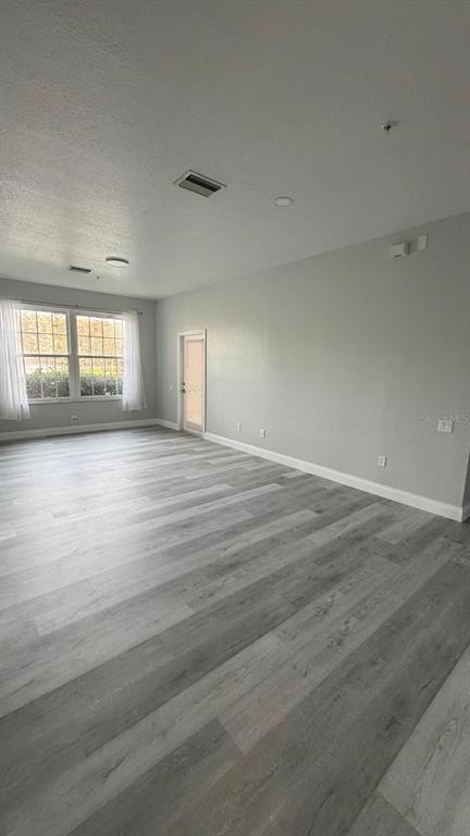 13584 Turtle Marsh Loop, Unit 113 Orlando, FL 32837 - Photo 16 of 29 an empty room with wooden floor and windows