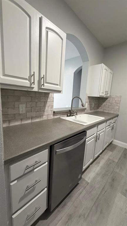 13584 Turtle Marsh Loop, Unit 113 Orlando, FL 32837 - Photo 18 of 29 a kitchen with granite countertop a sink stainless steel appliances and cabinets