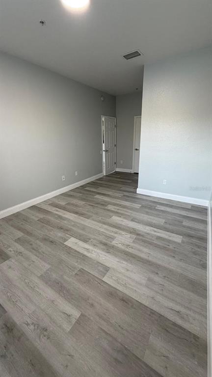 13584 Turtle Marsh Loop, Unit 113 Orlando, FL 32837 - Photo 20 of 29 a view of empty room with wooden floor