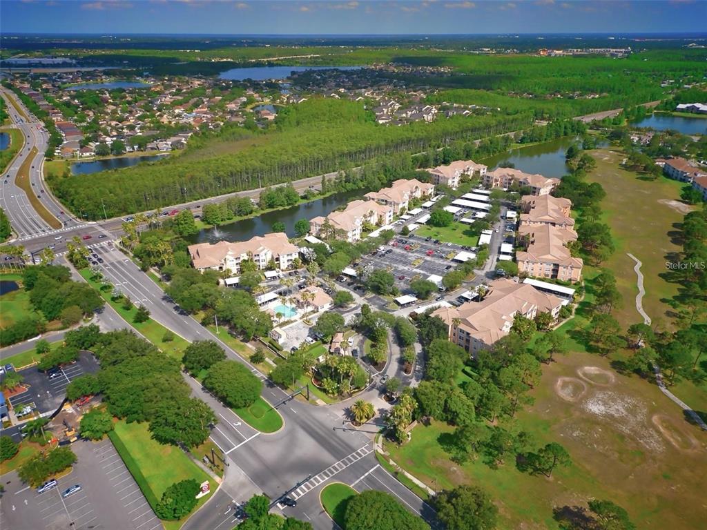 13584 Turtle Marsh Loop, Unit 113 Orlando, FL 32837 - Photo 2 of 29 a view of a golf course with a lake