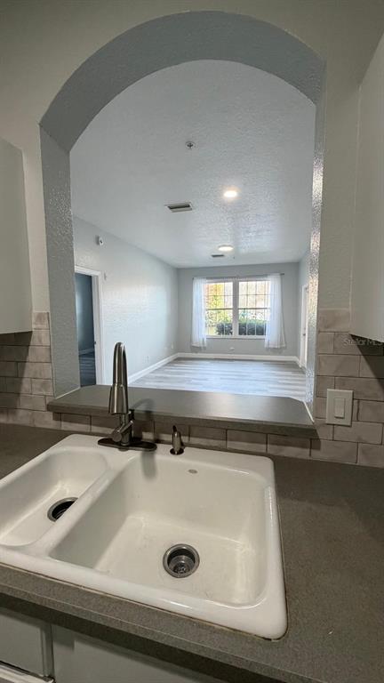 13584 Turtle Marsh Loop, Unit 113 Orlando, FL 32837 - Photo 22 of 29 a view of a sink a faucet a mirror and window in a room