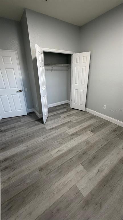 13584 Turtle Marsh Loop, Unit 113 Orlando, FL 32837 - Photo 23 of 29 an empty room with wooden floor and windows