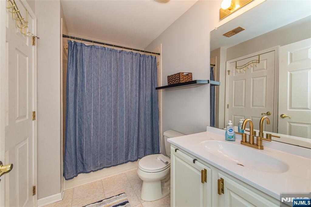 454 Cambridge Drive Butler, NJ 07405 - Photo 15 of 38 a bathroom with a sink a toilet and shower