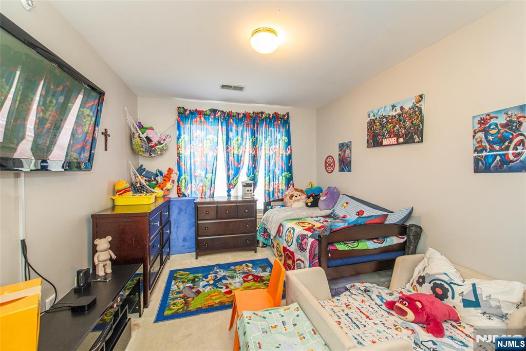 454 Cambridge Drive Butler, NJ 07405 - Photo 16 of 38 a bed room with furniture and a baby crib