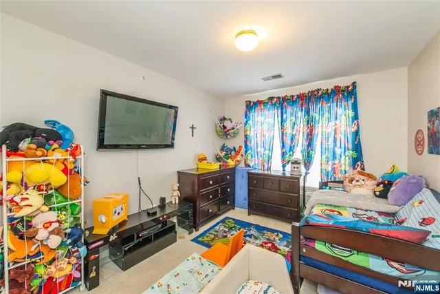 a bed room with furniture and a flat screen tv