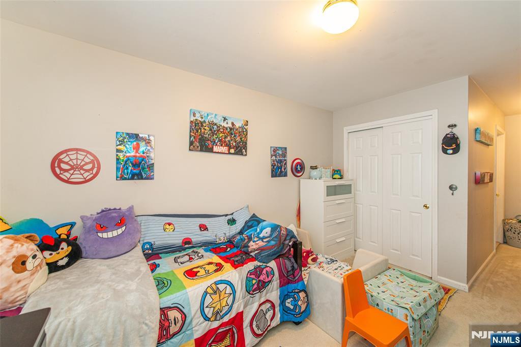 454 Cambridge Drive Butler, NJ 07405 - Photo 18 of 38 a bedroom with a bed and a window