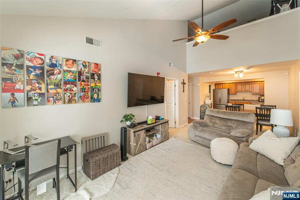 454 Cambridge Drive Butler, NJ 07405 - Photo 4 of 38 a living room with furniture and a flat screen tv