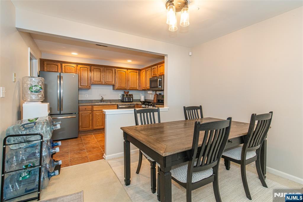 454 Cambridge Drive Butler, NJ 07405 - Photo 5 of 38 a view of a dining room with furniture and a kitchen view
