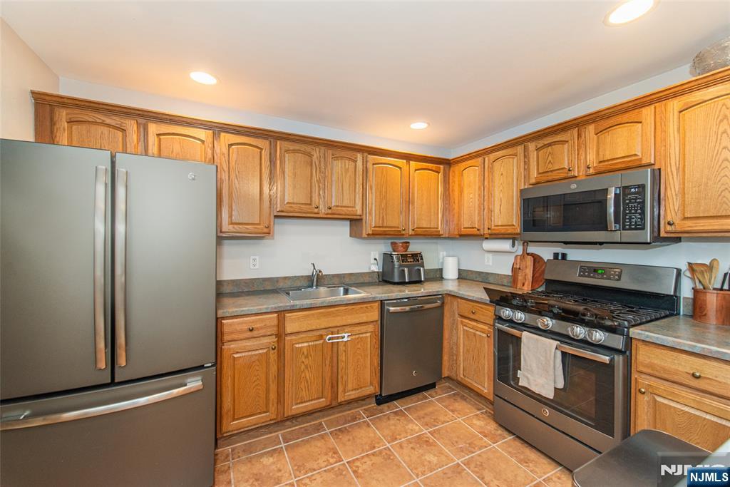454 Cambridge Drive Butler, NJ 07405 - Photo 8 of 38 a kitchen with stainless steel appliances granite countertop a refrigerator stove microwave and sink