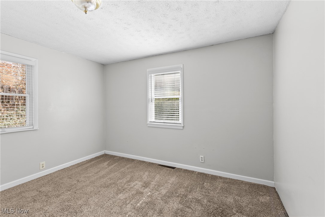 133 Harding Avenue Wheeling, WV 26003 - Photo 16 of 29 Carpeted spare room featuring visible vents, baseboards, and a textured ceiling