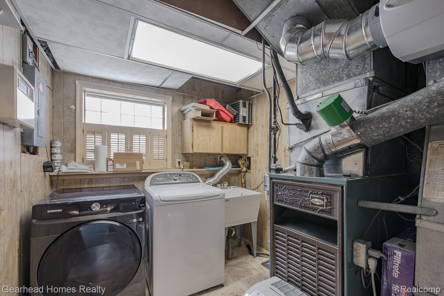 3356 Harding Street Dearborn, MI 48124 - Photo 28 of 48 Utility area featuring a single window with plantation shutters, built-in cabinetry, an integrated utility sink, and a permanent light fixture
