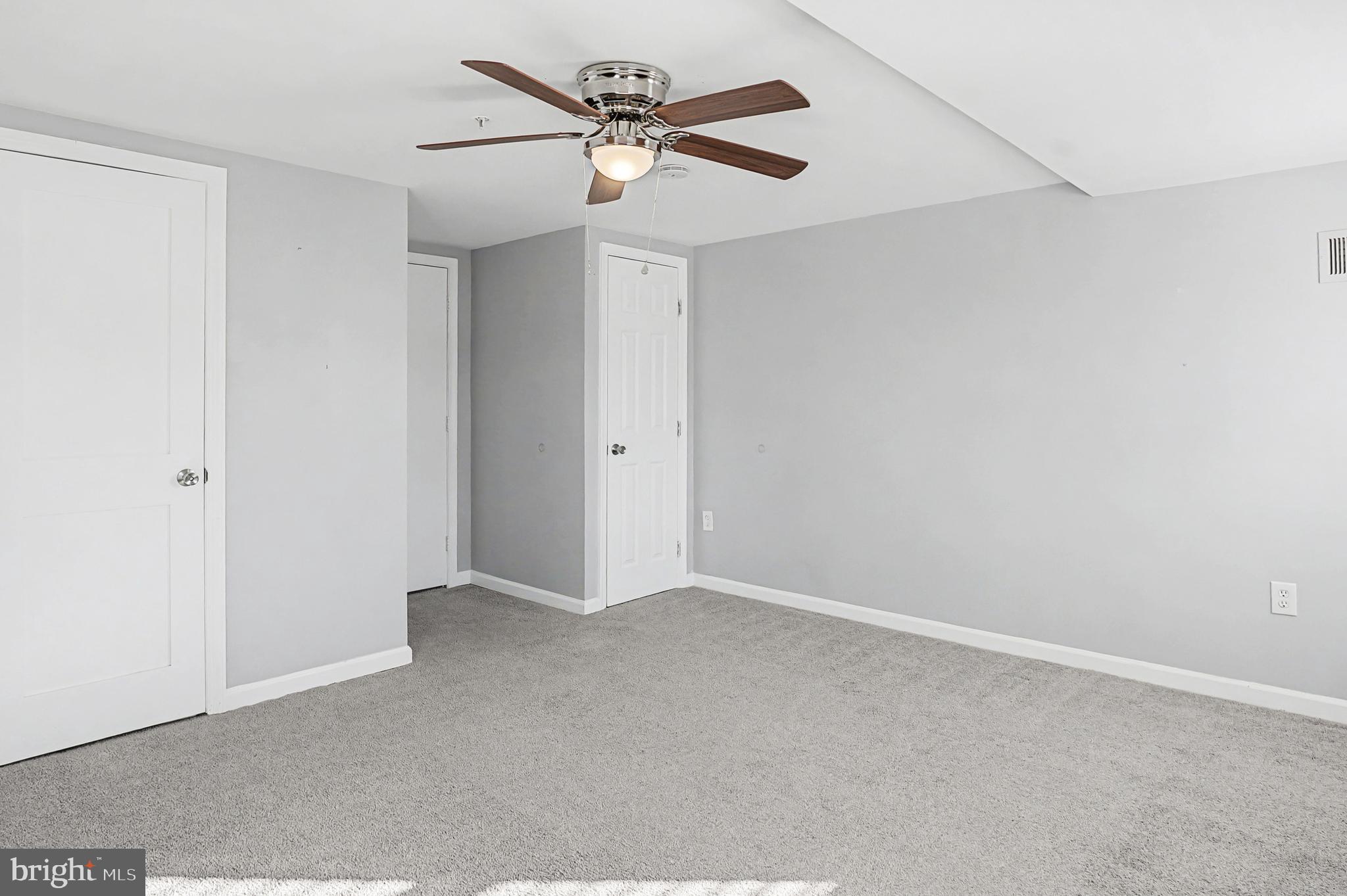 1032 North Broadway Baltimore, MD 21205 - Photo 20 of 28 an empty room with a ceiling fan and a window