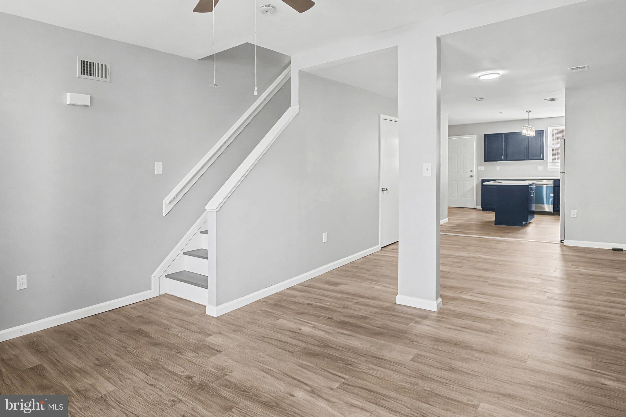 1032 North Broadway Baltimore, MD 21205 - Photo 2 of 28 a view of a hallway view with wooden floor and staircase