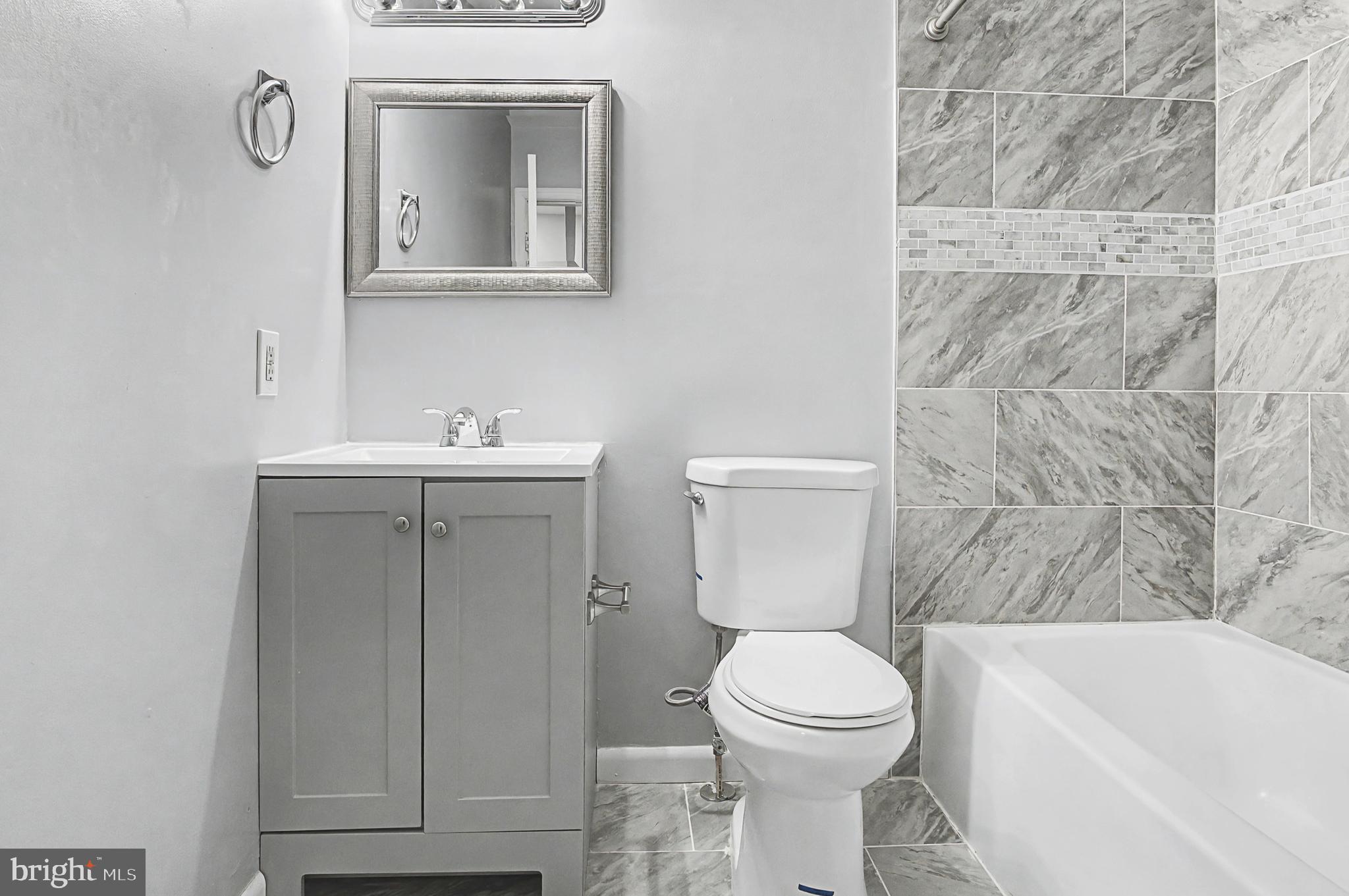 1032 North Broadway Baltimore, MD 21205 - Photo 5 of 28 a bathroom with a toilet sink and mirror