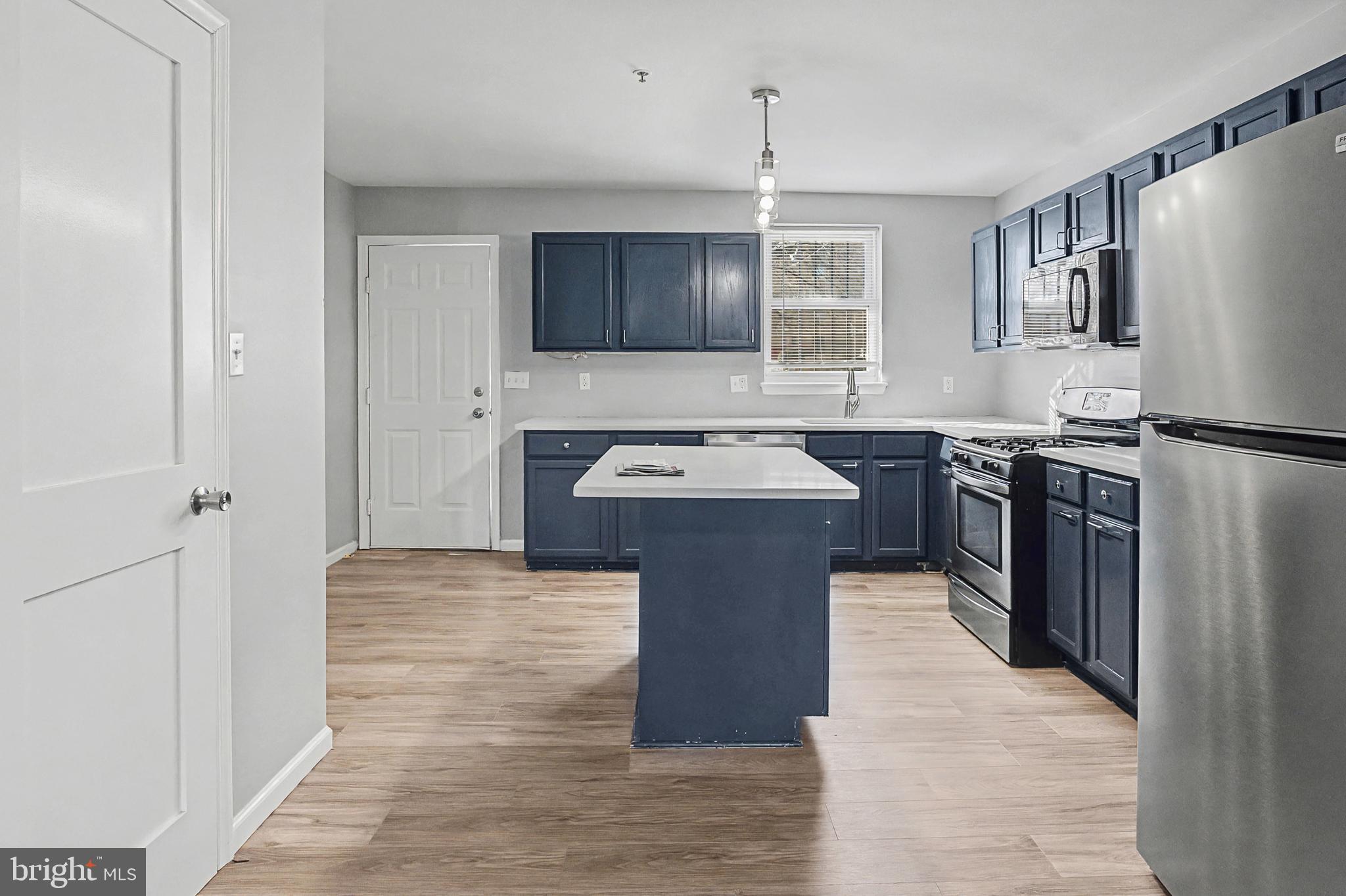 1032 North Broadway Baltimore, MD 21205 - Photo 8 of 28 a kitchen with stainless steel appliances granite countertop a sink stove and refrigerator