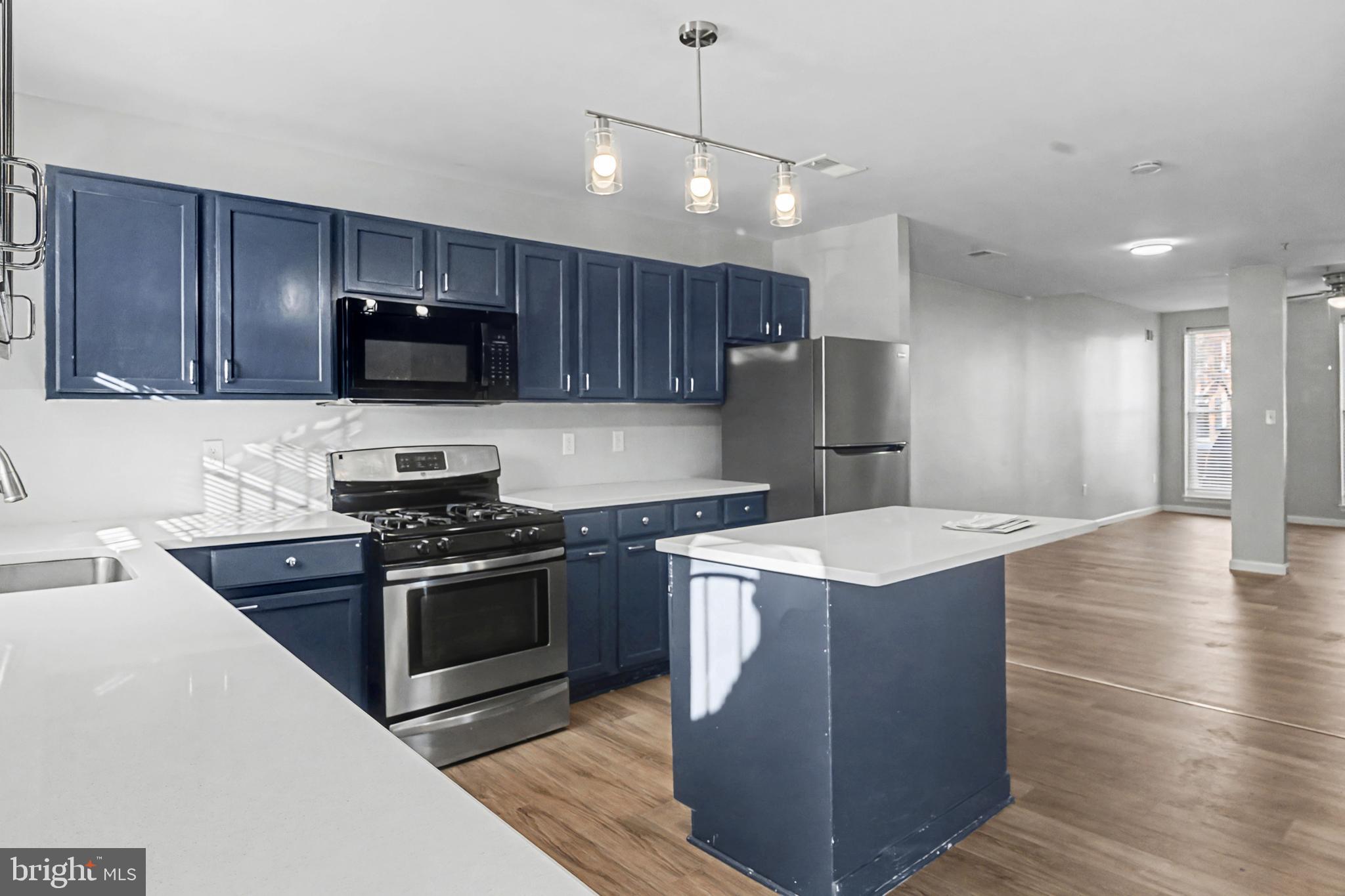 1032 North Broadway Baltimore, MD 21205 - Photo 10 of 28 a kitchen with stainless steel appliances granite countertop a stove a sink a refrigerator and a oven