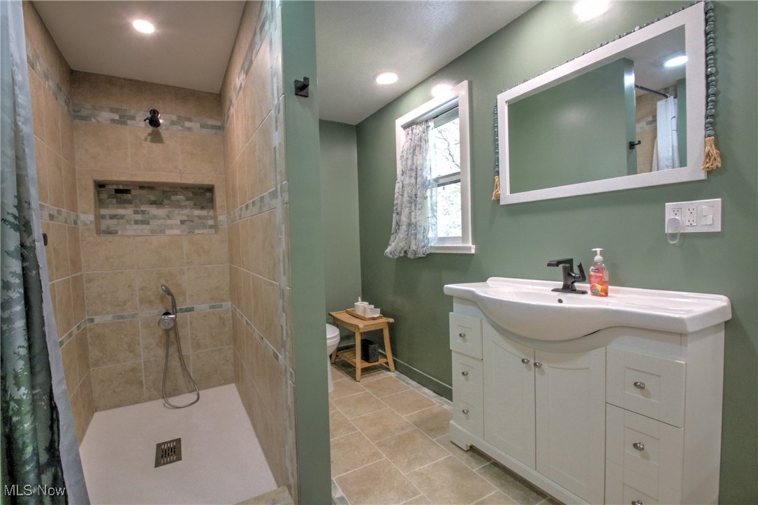11375 Bean Road Chardon, OH 44024 - Photo 28 of 50 Bathroom with a stall shower, vanity, light tile patterned floors, and recessed lighting