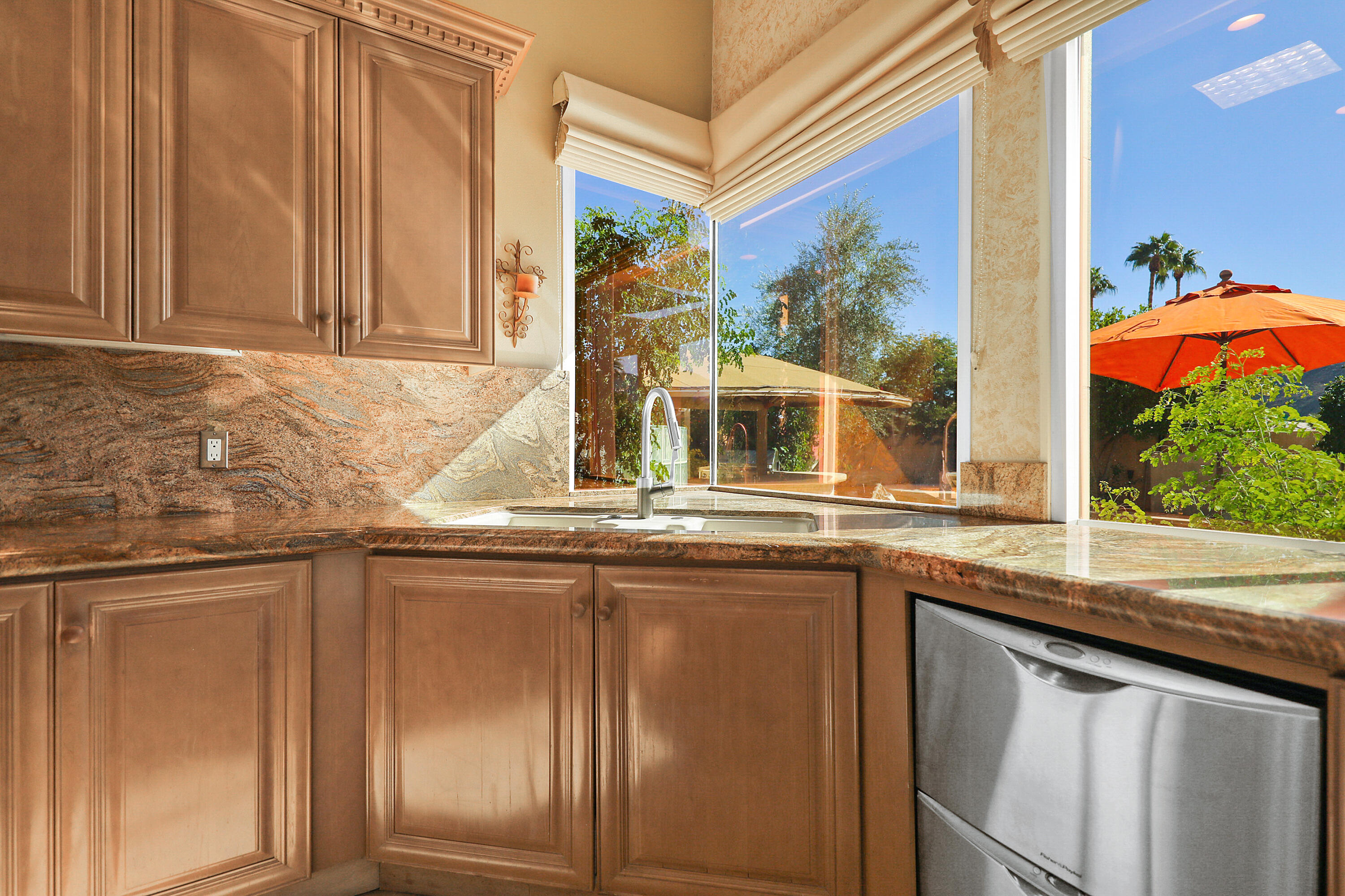 78680 Ave Tujunga La Quinta, CA 92253 - Photo 11 of 41 a kitchen with stainless steel appliances granite countertop a sink and a window