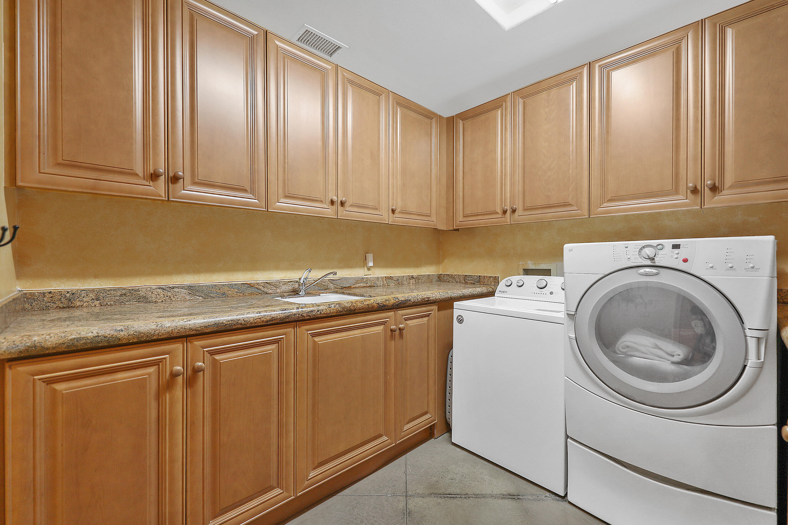 78680 Ave Tujunga La Quinta, CA 92253 - Photo 18 of 41 a kitchen with granite countertop cabinets stainless steel appliances and sink