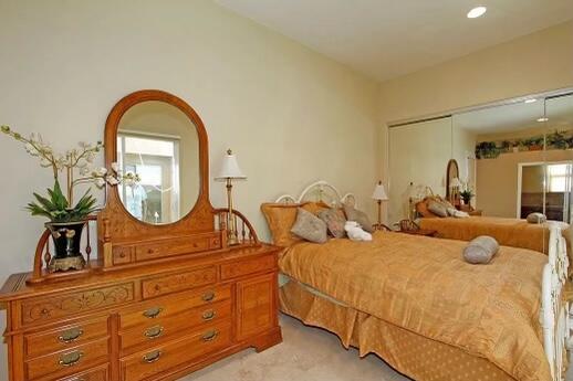 78680 Ave Tujunga La Quinta, CA 92253 - Photo 26 of 41 a bedroom with bed a mirror with the potted plants