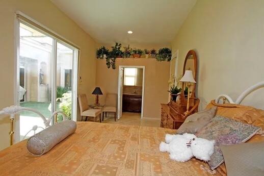 78680 Ave Tujunga La Quinta, CA 92253 - Photo 28 of 41 a bedroom with a bed and a large mirror