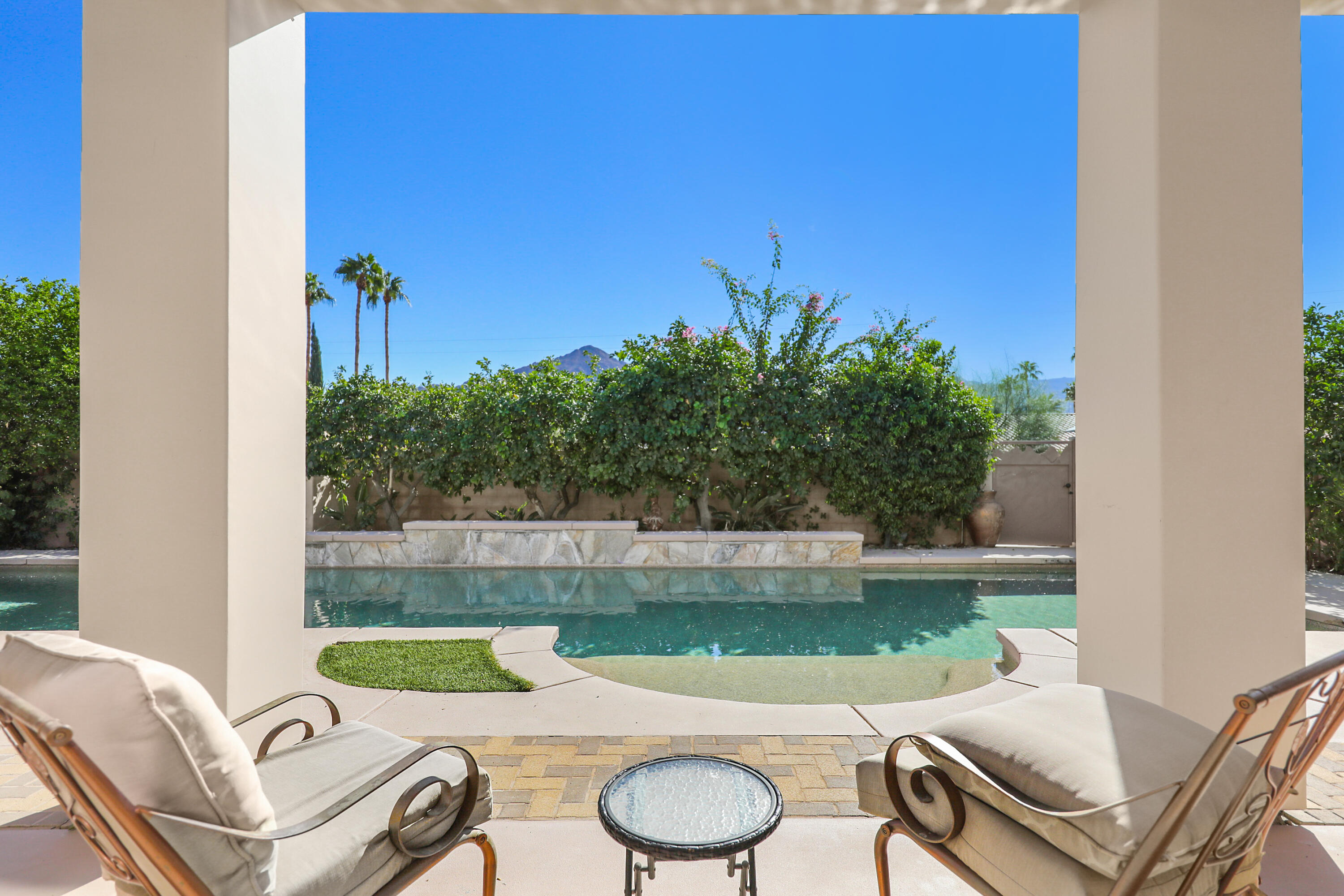 78680 Ave Tujunga La Quinta, CA 92253 - Photo 29 of 41 a view of a chairs and table in patio with a lake view