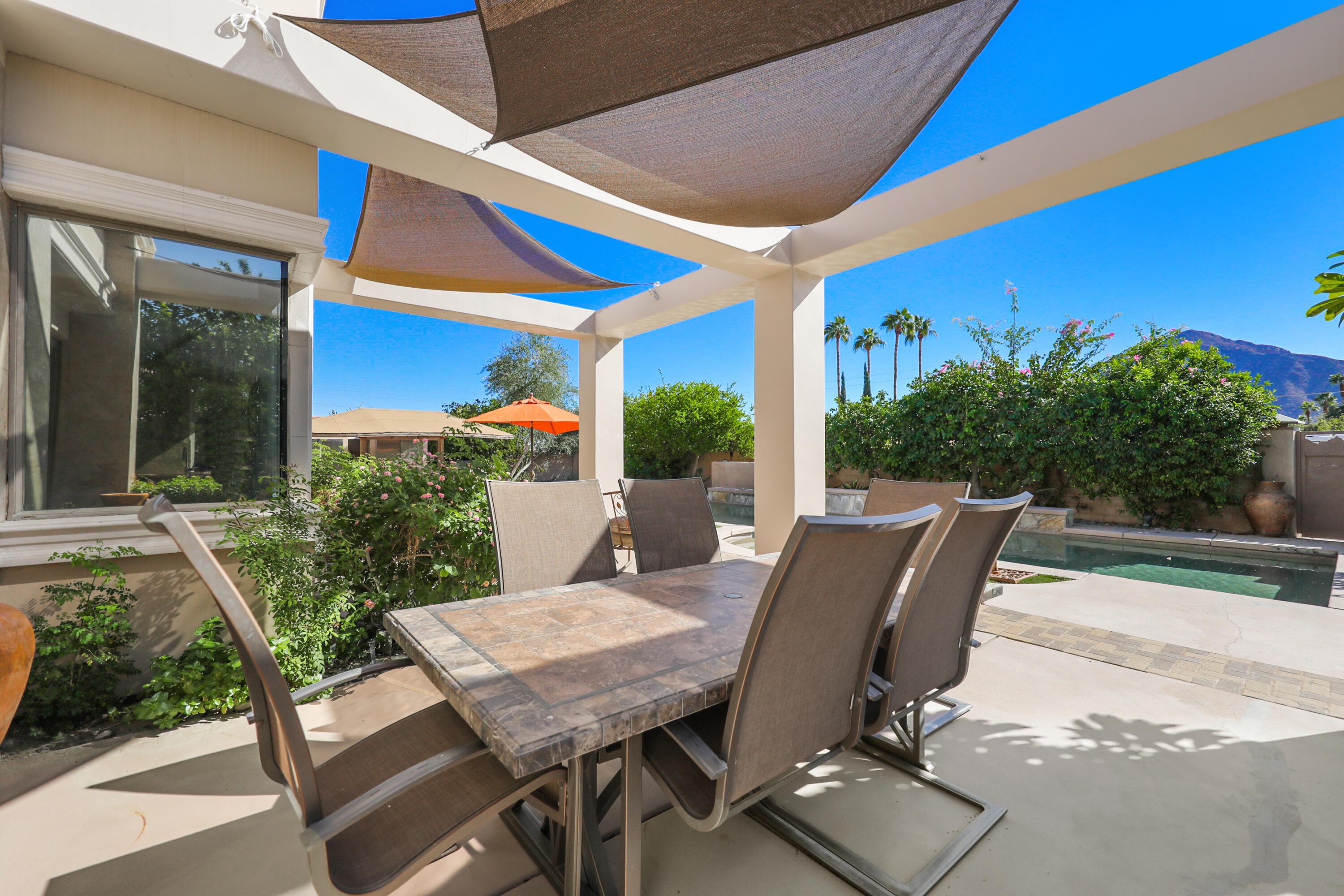 78680 Ave Tujunga La Quinta, CA 92253 - Photo 30 of 41 a view of a patio with table and chairs and potted plants
