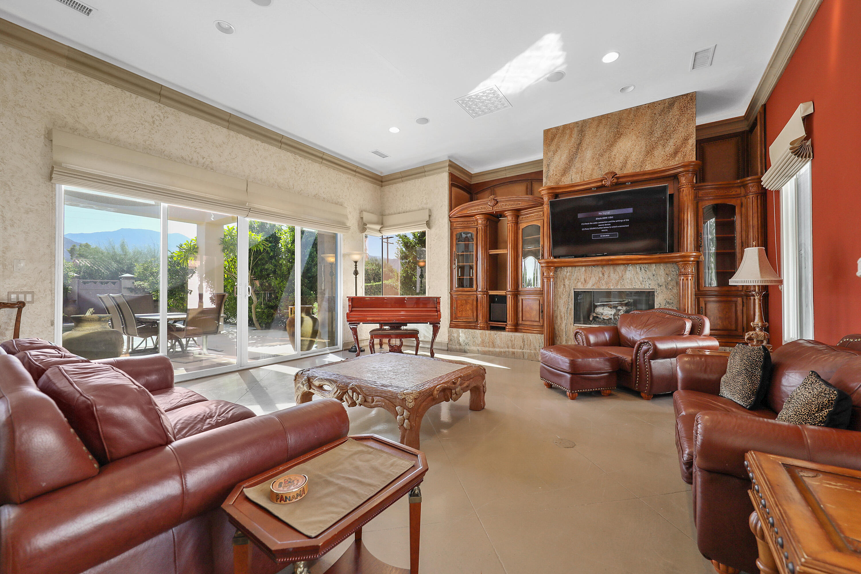 78680 Ave Tujunga La Quinta, CA 92253 - Photo 3 of 41 a living room with fireplace furniture and a large window