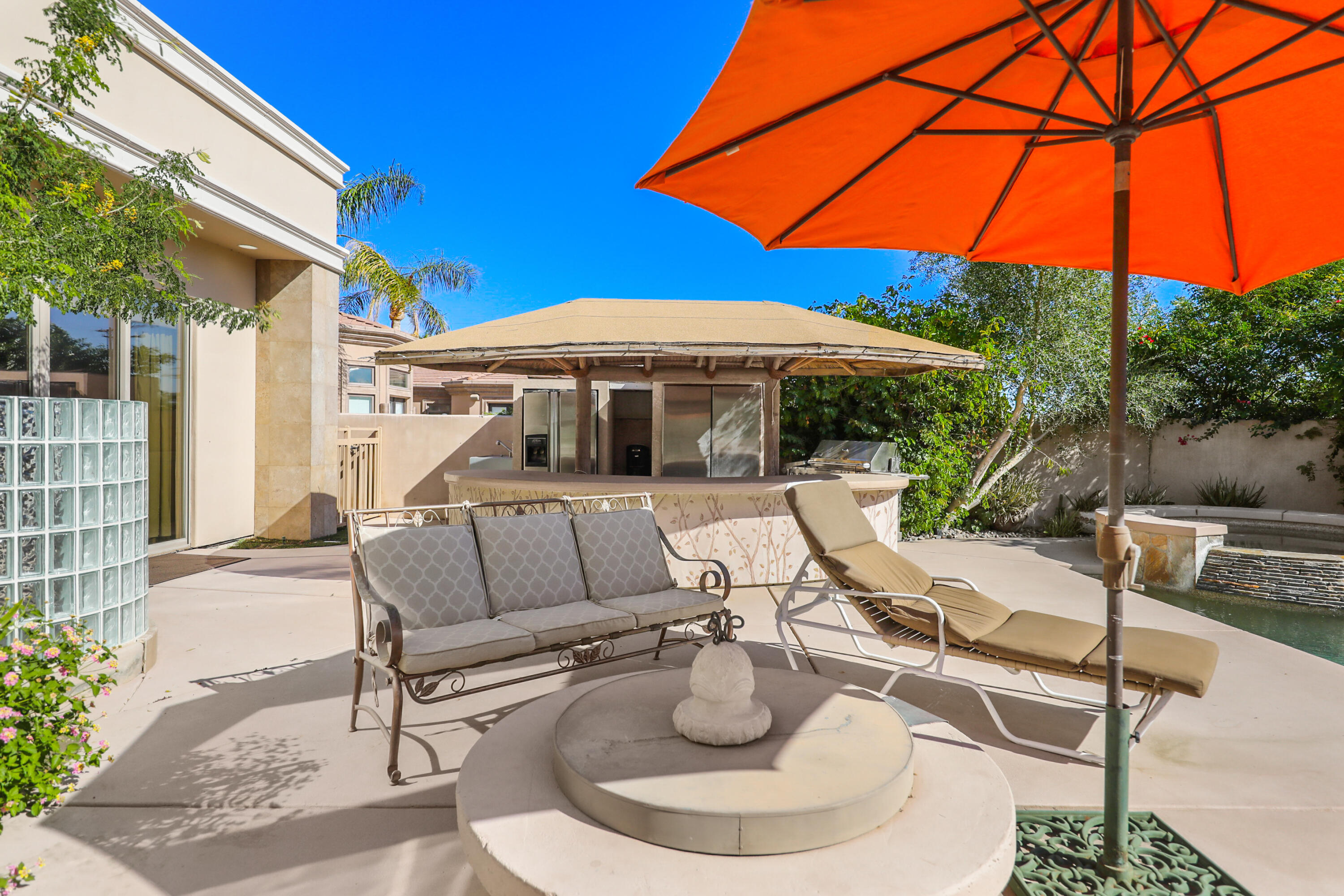 78680 Ave Tujunga La Quinta, CA 92253 - Photo 32 of 41 a balcony with table and chairs under an umbrella