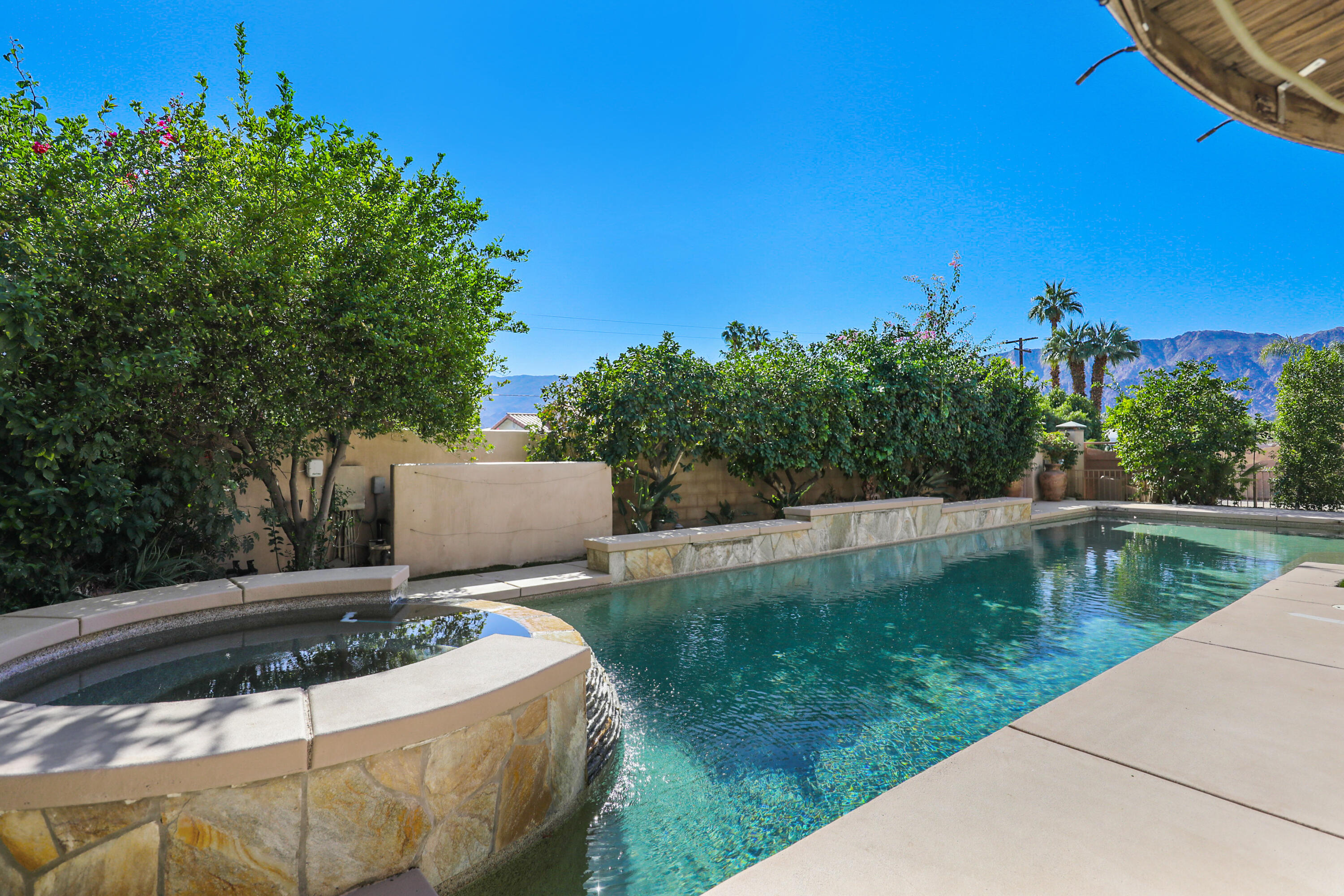 78680 Ave Tujunga La Quinta, CA 92253 - Photo 33 of 41 a view of a swimming pool with a patio and a yard