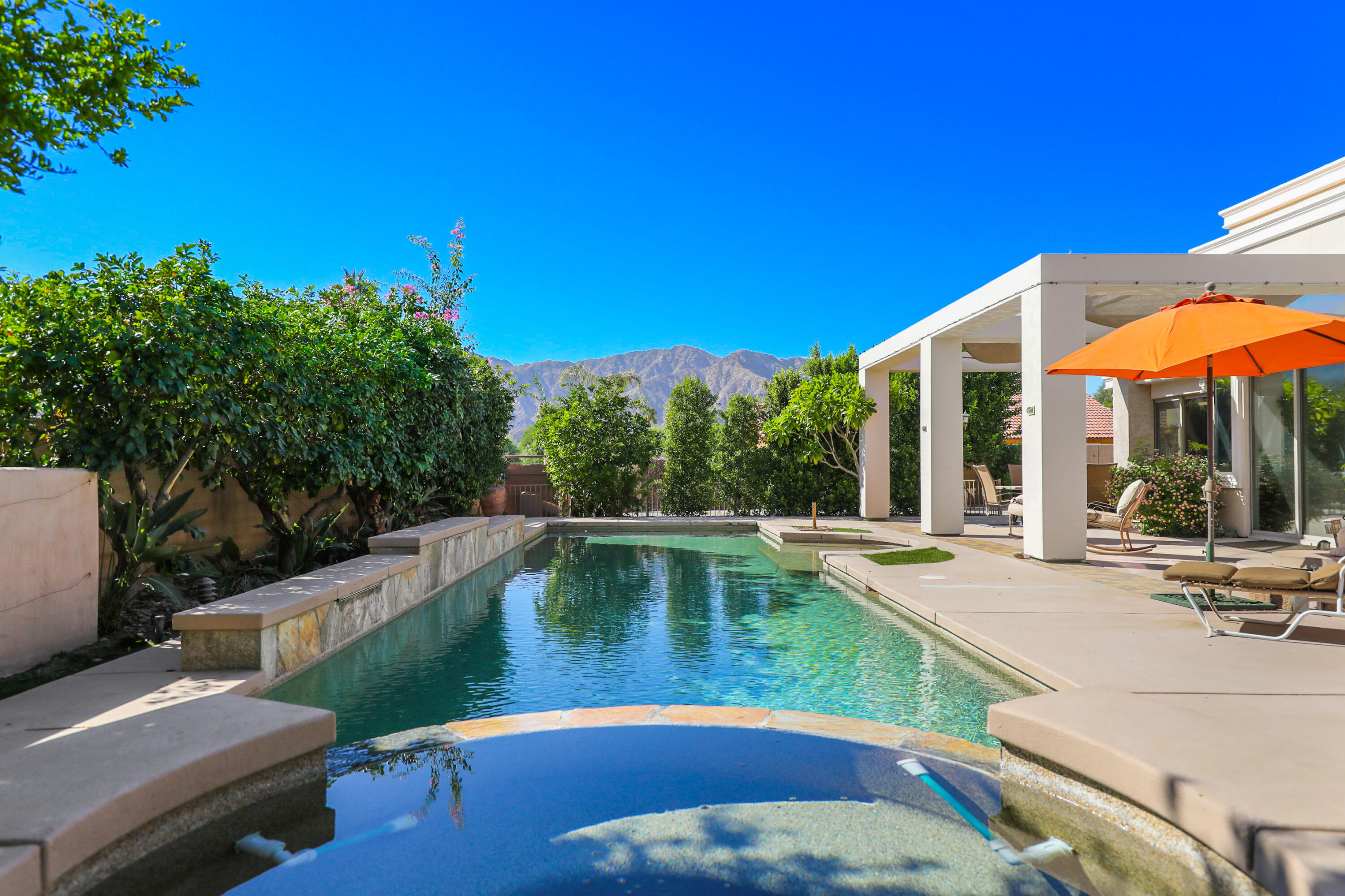 78680 Ave Tujunga La Quinta, CA 92253 - Photo 34 of 41 a view of a swimming pool with a lounge chairs