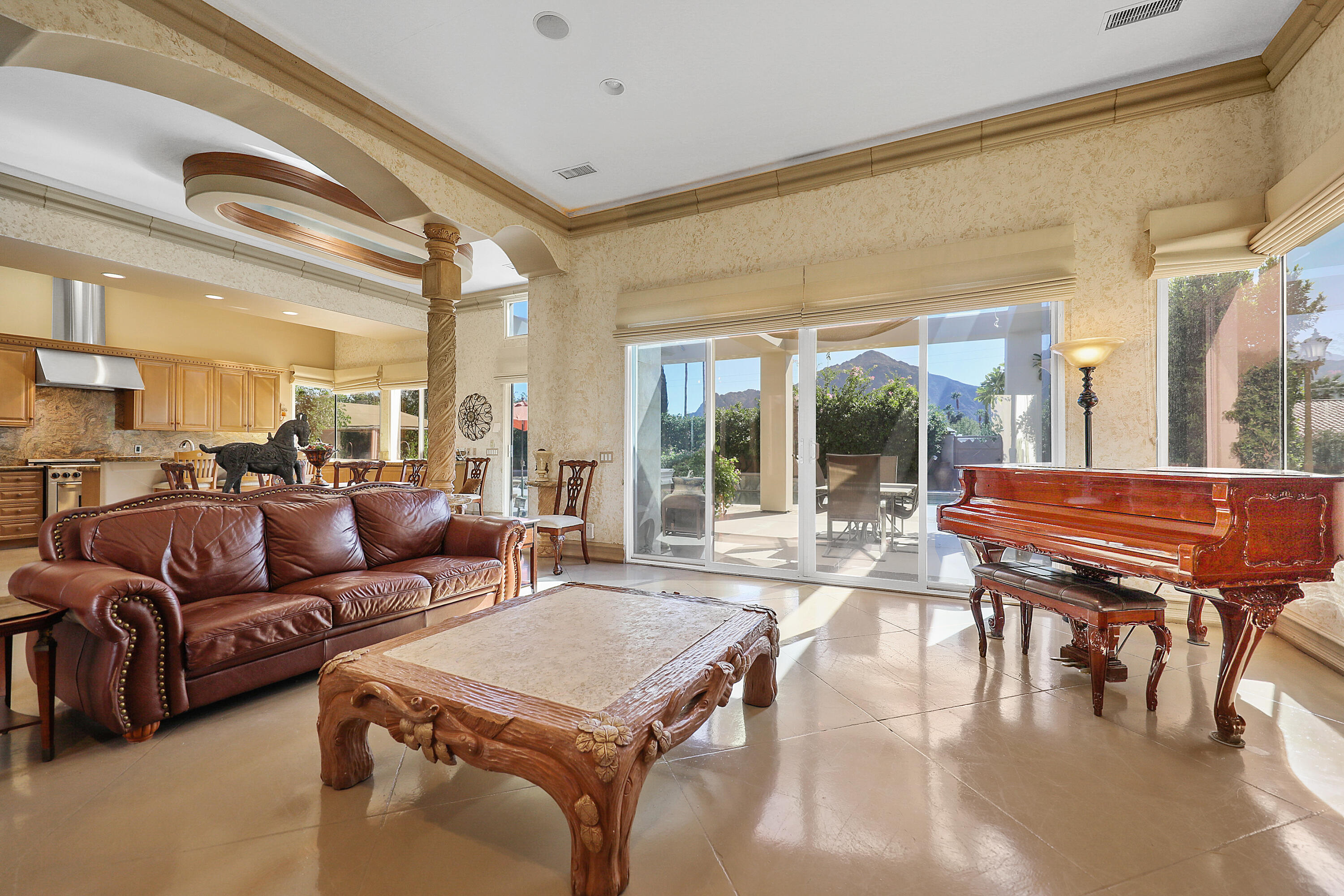 78680 Ave Tujunga La Quinta, CA 92253 - Photo 5 of 41 a living room with furniture a large window and a table