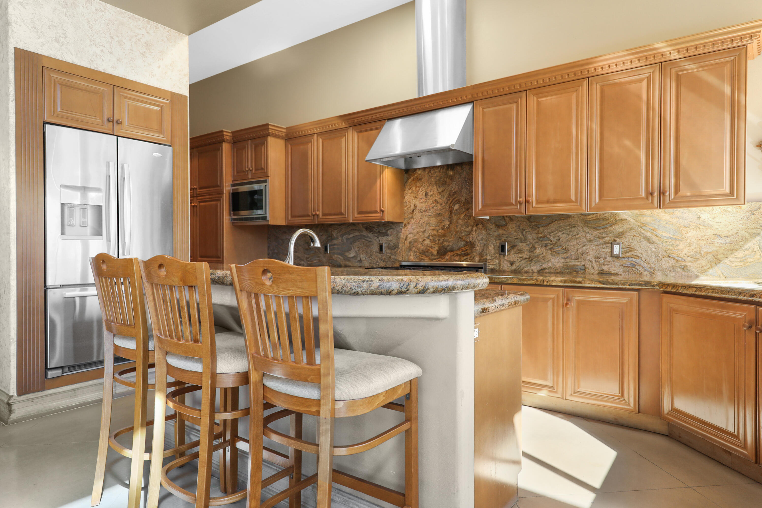78680 Ave Tujunga La Quinta, CA 92253 - Photo 10 of 41 a kitchen with stainless steel appliances granite countertop a sink and a white cabinets