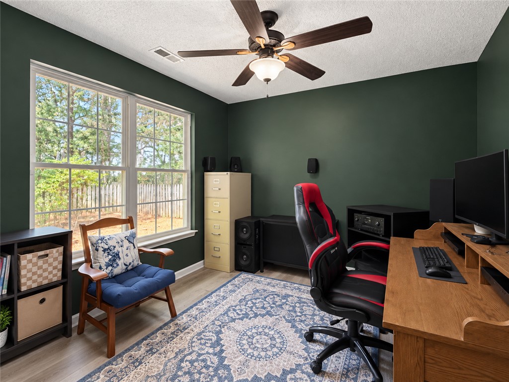 113 Grand Oak Circle Pendleton, SC 29670 - Photo 16 of 25 A spacious home workspace is illuminated by natural light from large multi-pane windows.