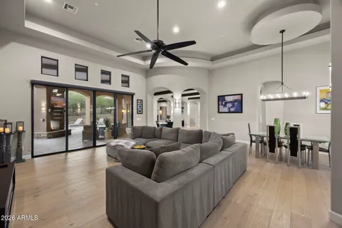 a living room with furniture kitchen and a chandelier