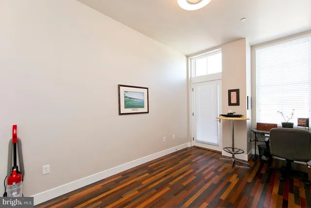 a view of a workspace with furniture and wooden floor