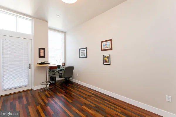 a view of a workspace with furniture and a window