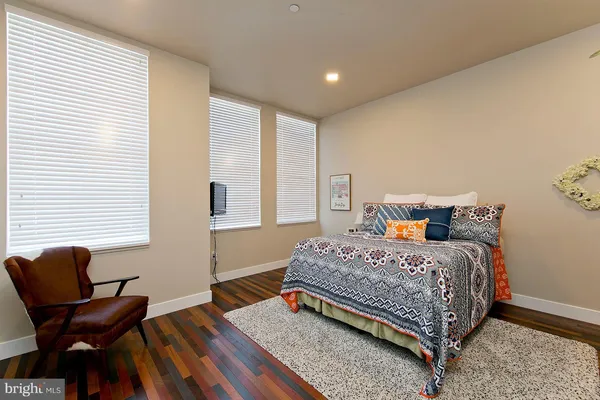 a bedroom with a bed and windows